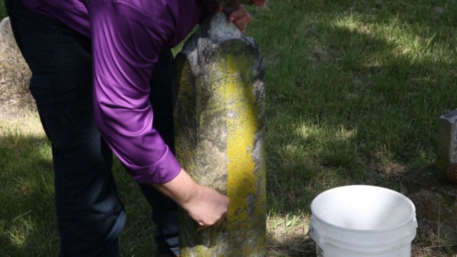 Cleaning tombstone - Western Heights Cemetery